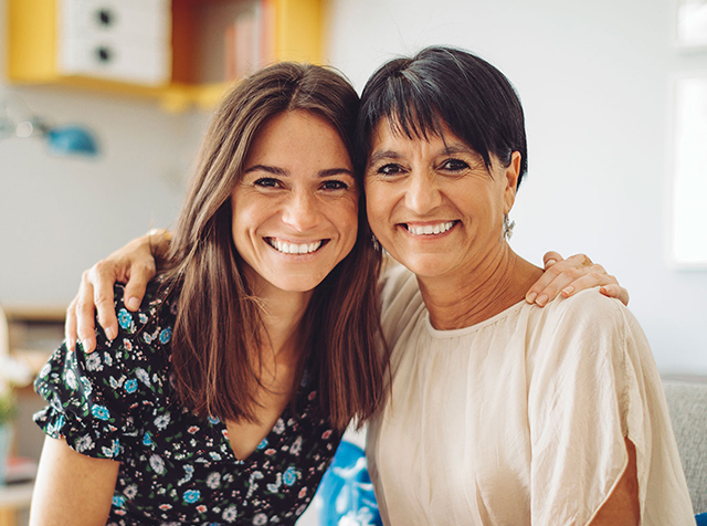 Mother and daughter smiling at the camera