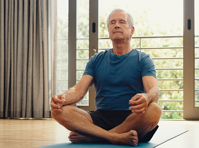 Man sitting on the floor with his legs crossed
