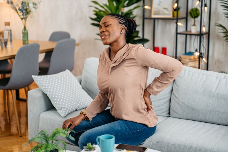 African American woman holding back in pain