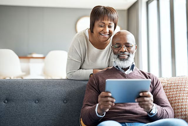 Couple looking at tablet at home