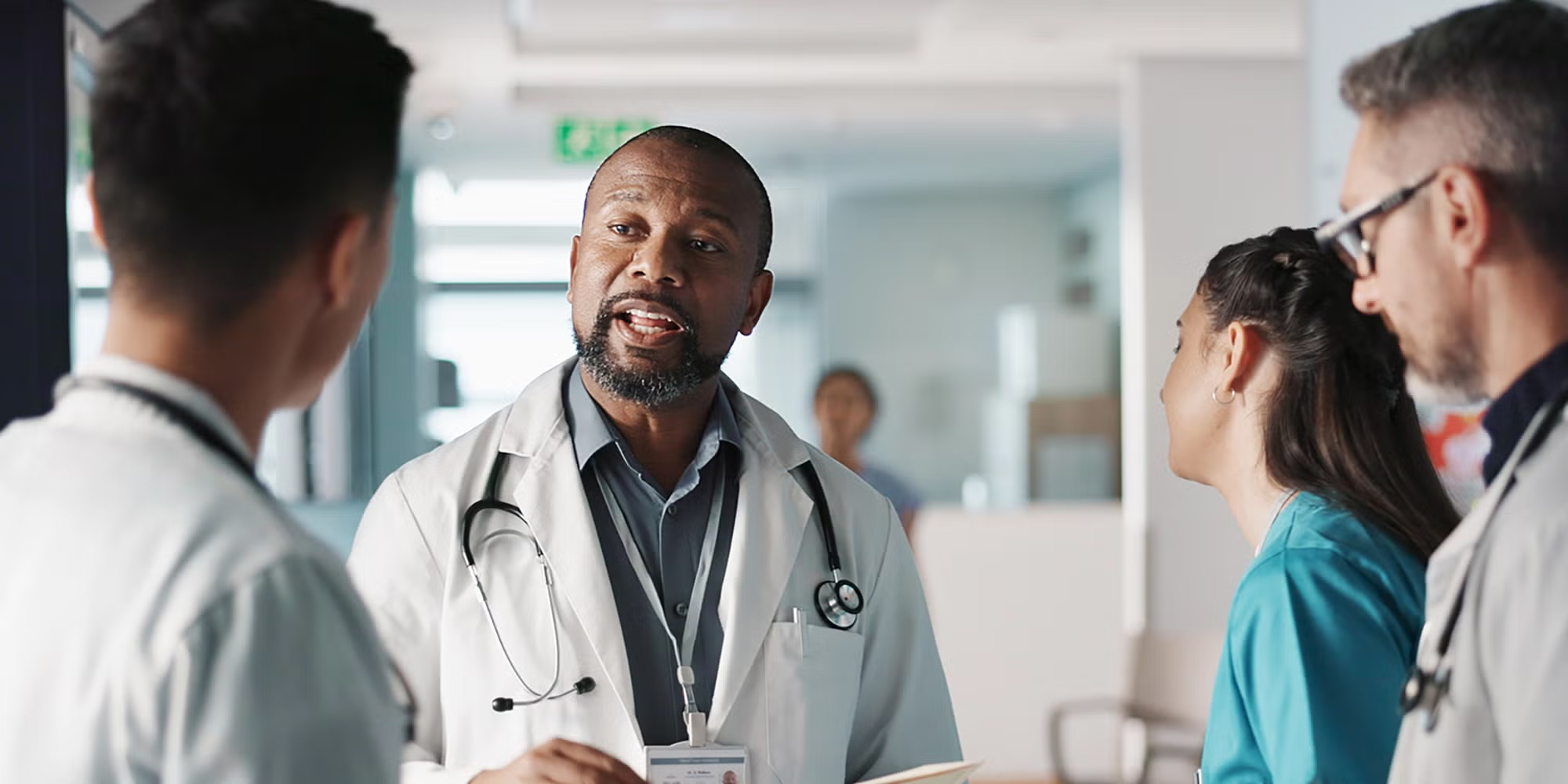 A group of providers talking in a hospital hallway