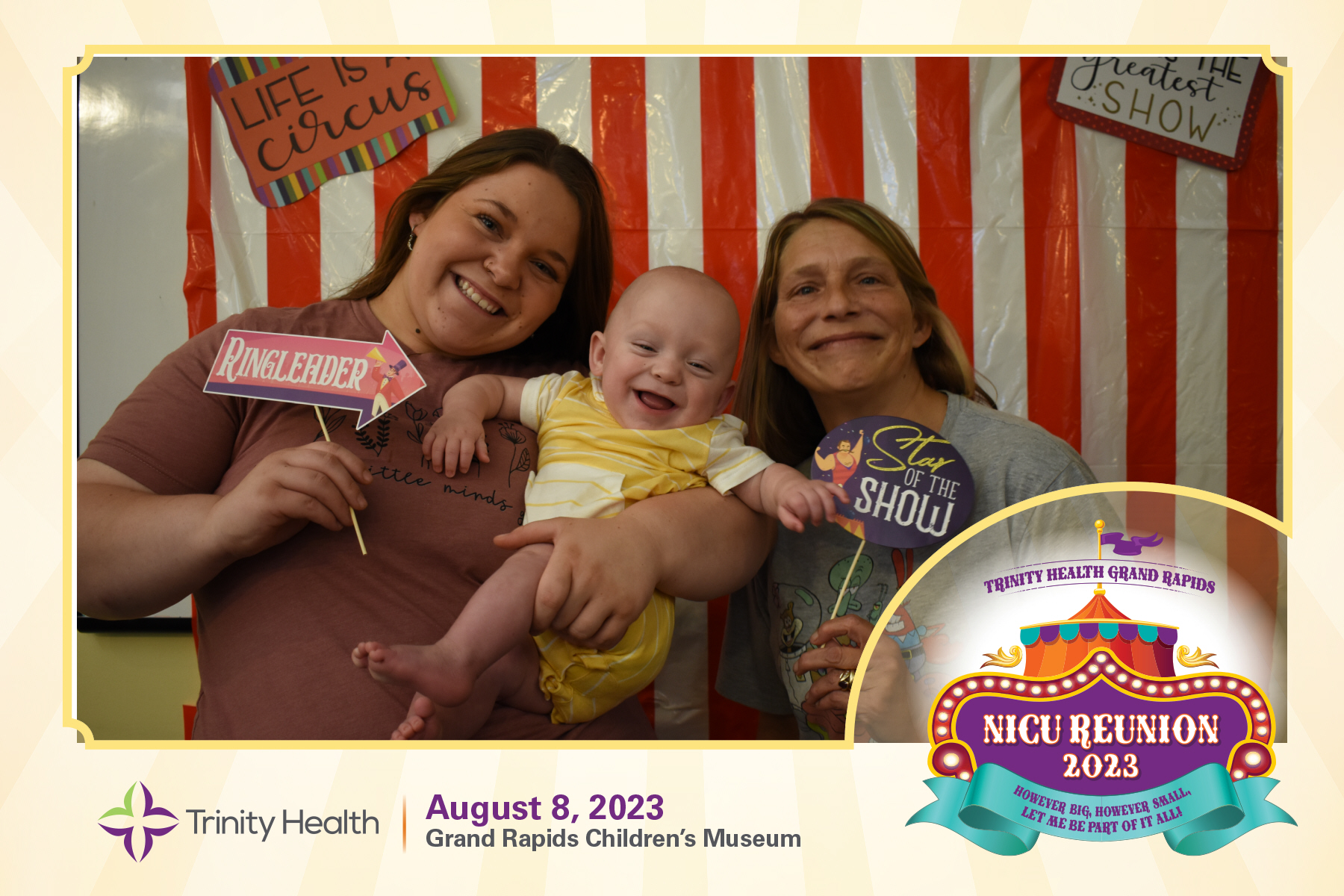 Family smiles for a photo booth at the NICU Reunion