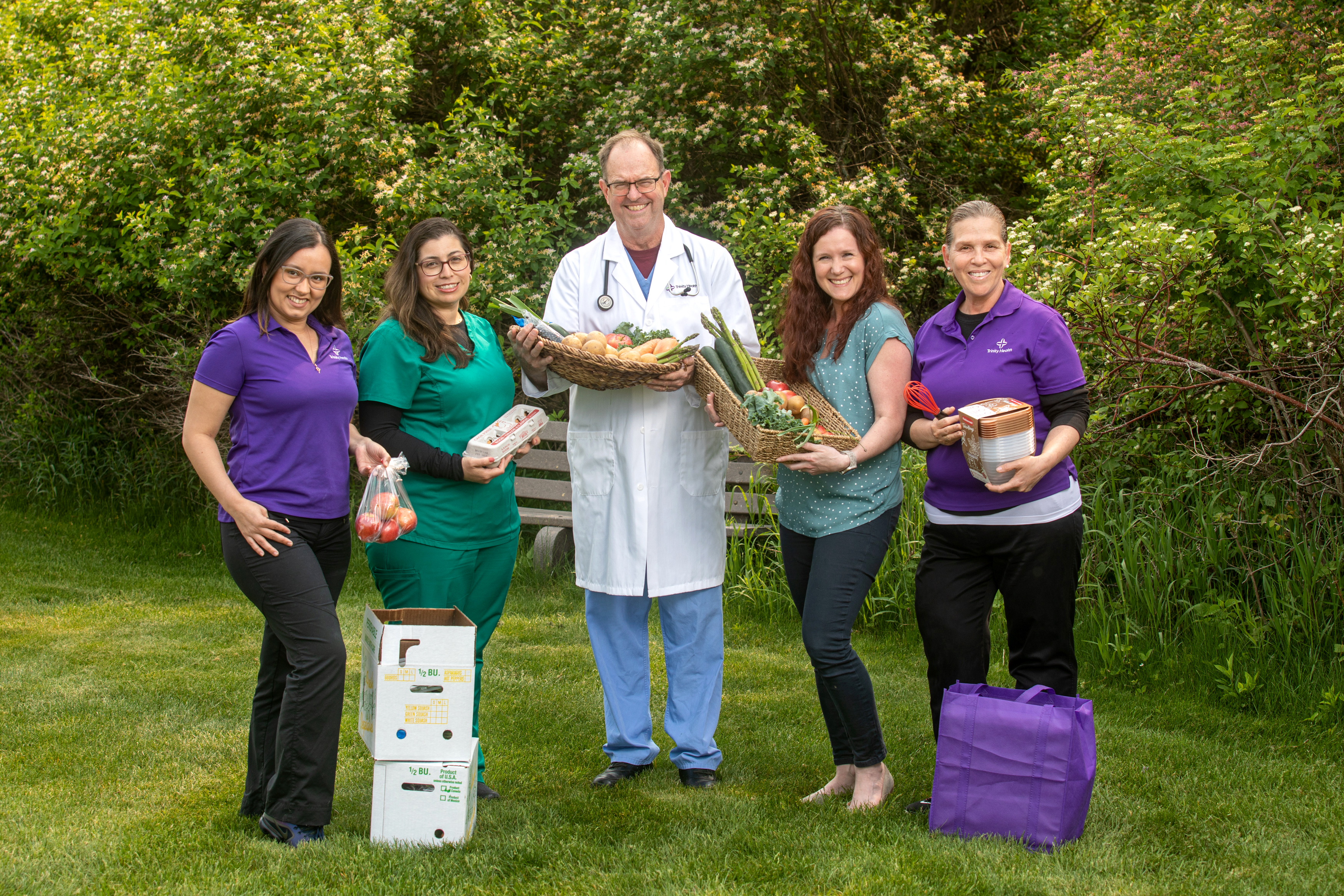 Trinity Health Medical Group - Sparta staff hold display a Healthy Food Box