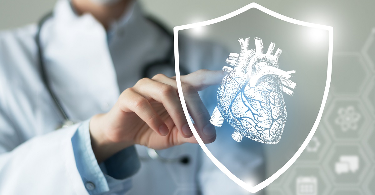 Clinical person pointing at a white illustration of an anatomical heart.