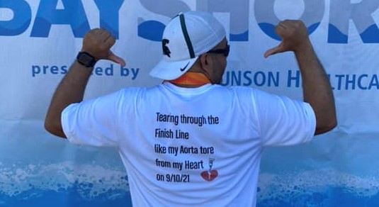 patient at race showing wording on back of his shirt