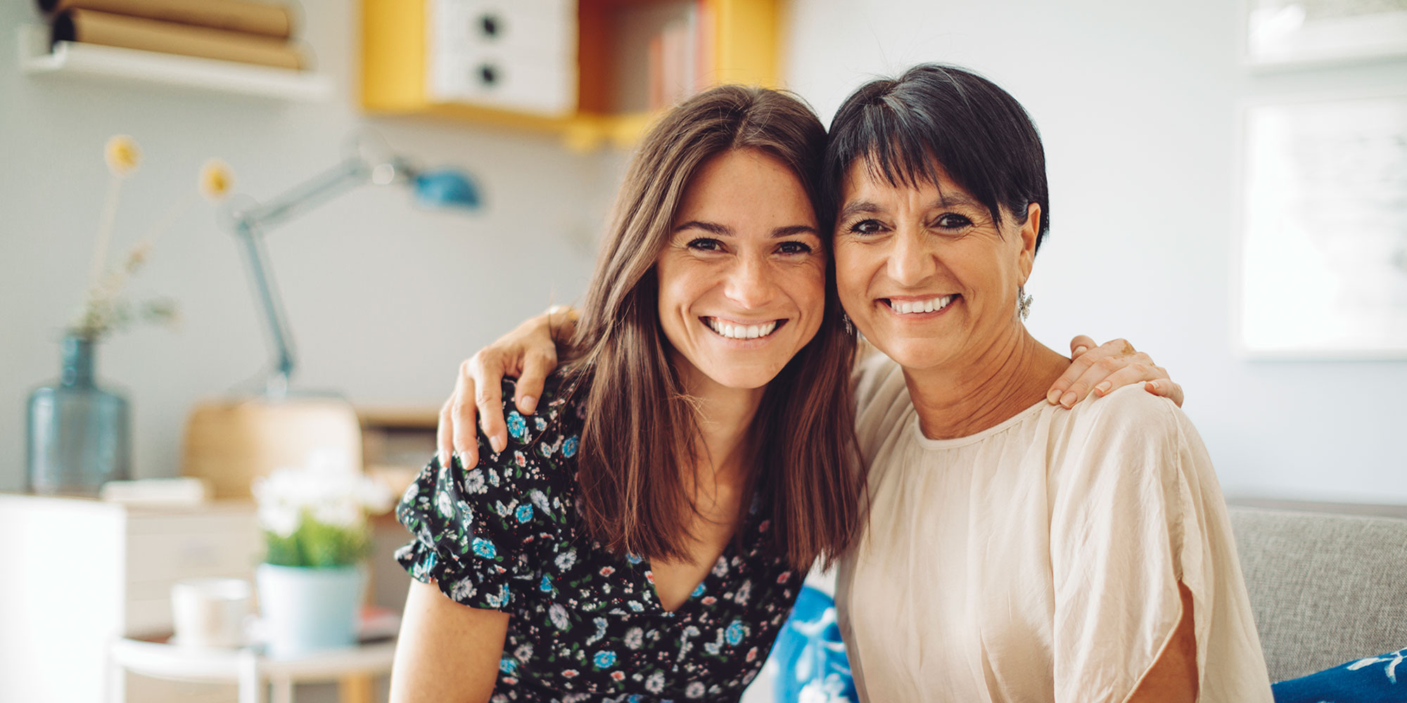 A mother and daughter share a tender moment together on the couch