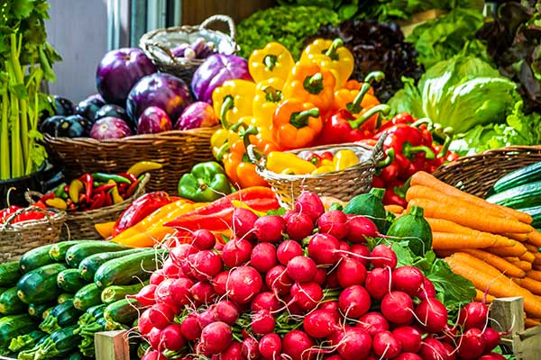 A large assortment of fruits and vegetables at a farmer's market